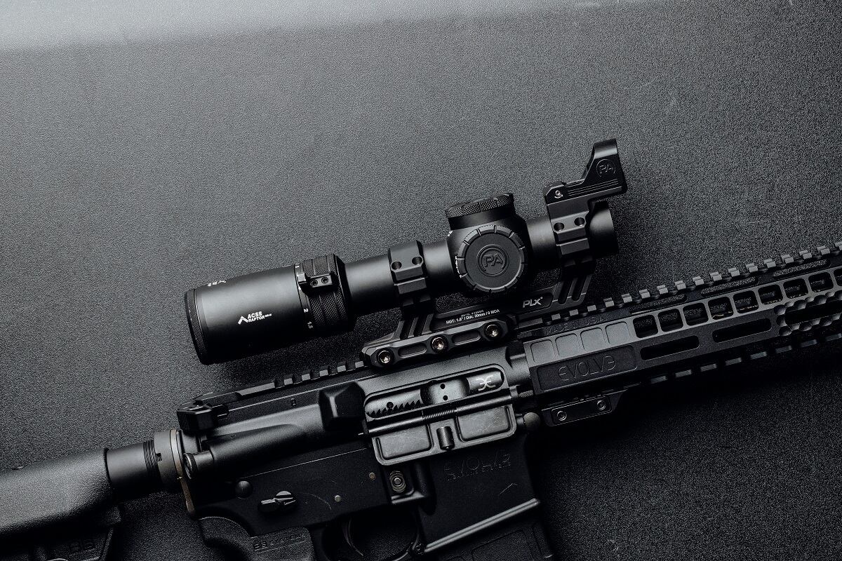 AR-15 rifle with accessories installed like a scope and red dot sight.